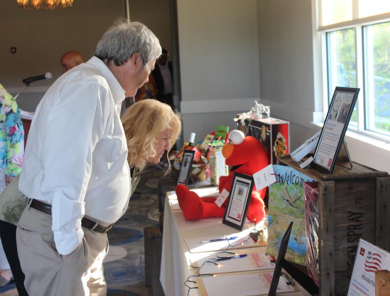 Potential bidders check out items up for auction before dinner is served at the annual "kukoo" gala. BY MATTHEW BERNAT